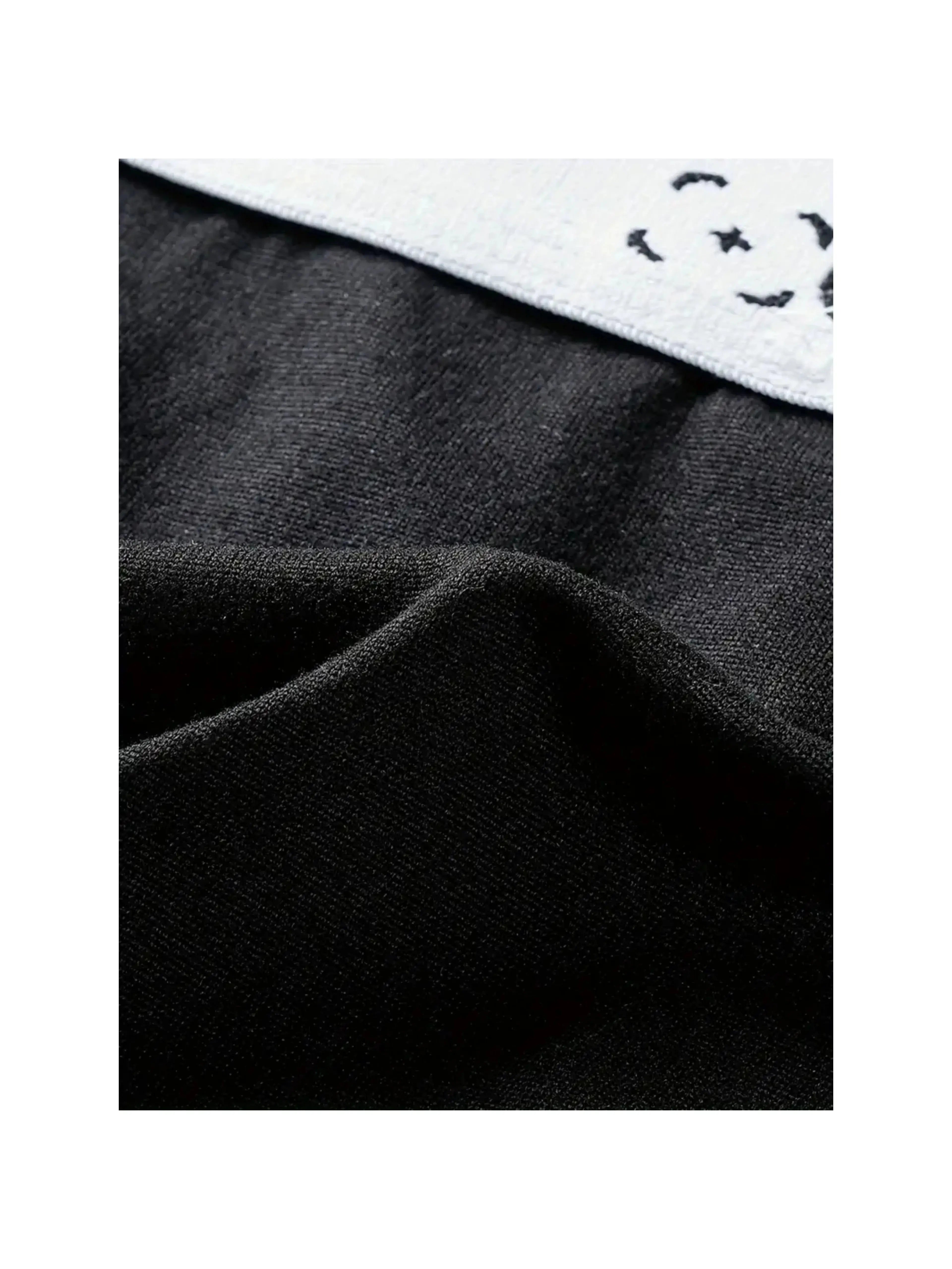 Detailed view of soft black fabric texture used in 10-pack men's breathable and stretchy boxer briefs.