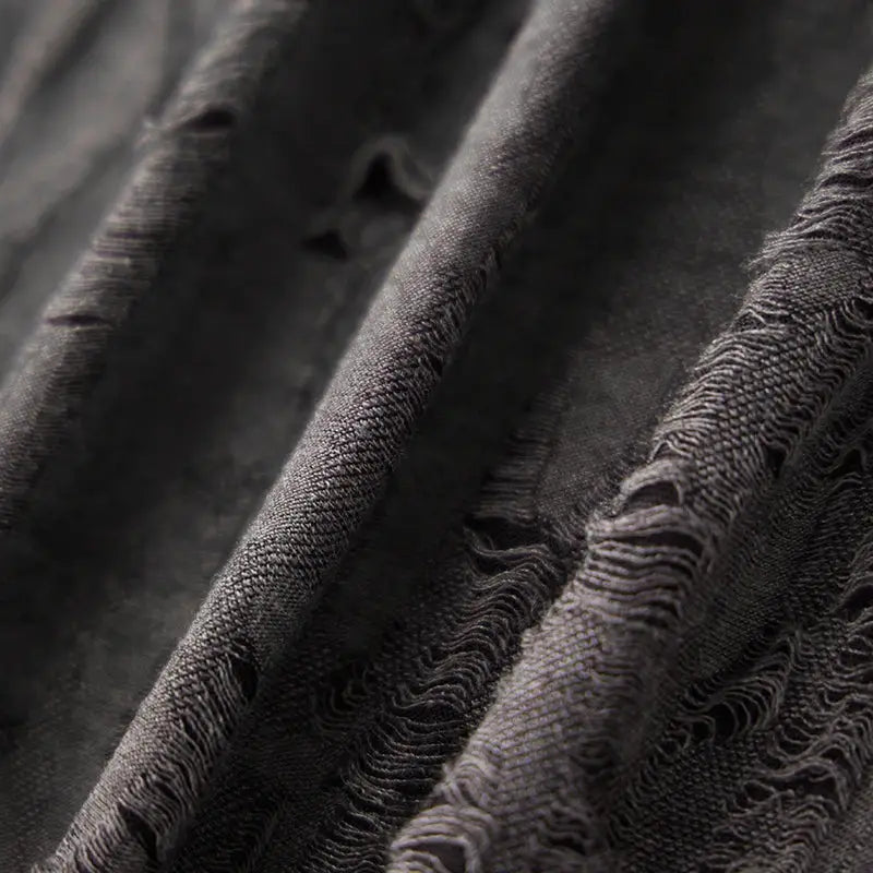 Close-up of fabric texture on charcoal gray men’s short sleeve T-shirt with distressed finish, ideal for casual summer wear.