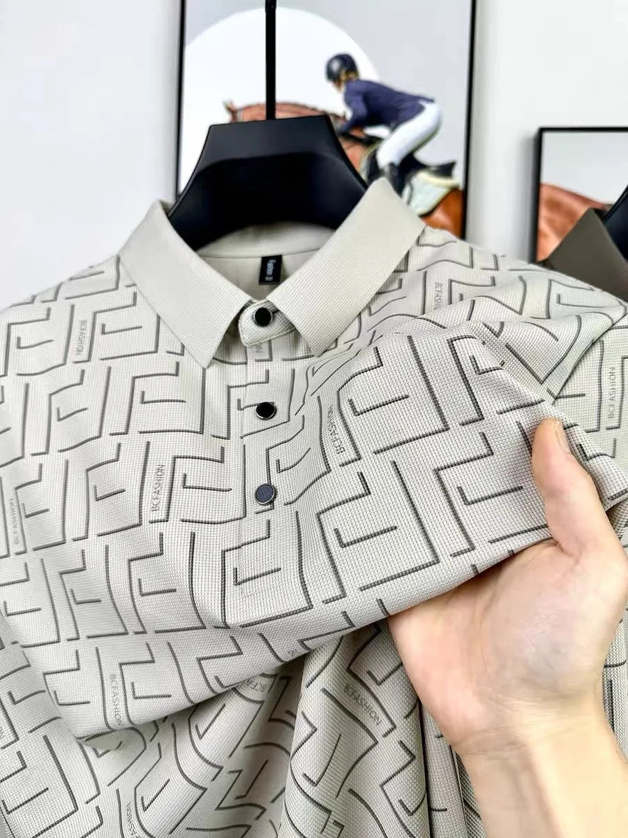 Beige silk t-shirt for men with geometric pattern held close-up.