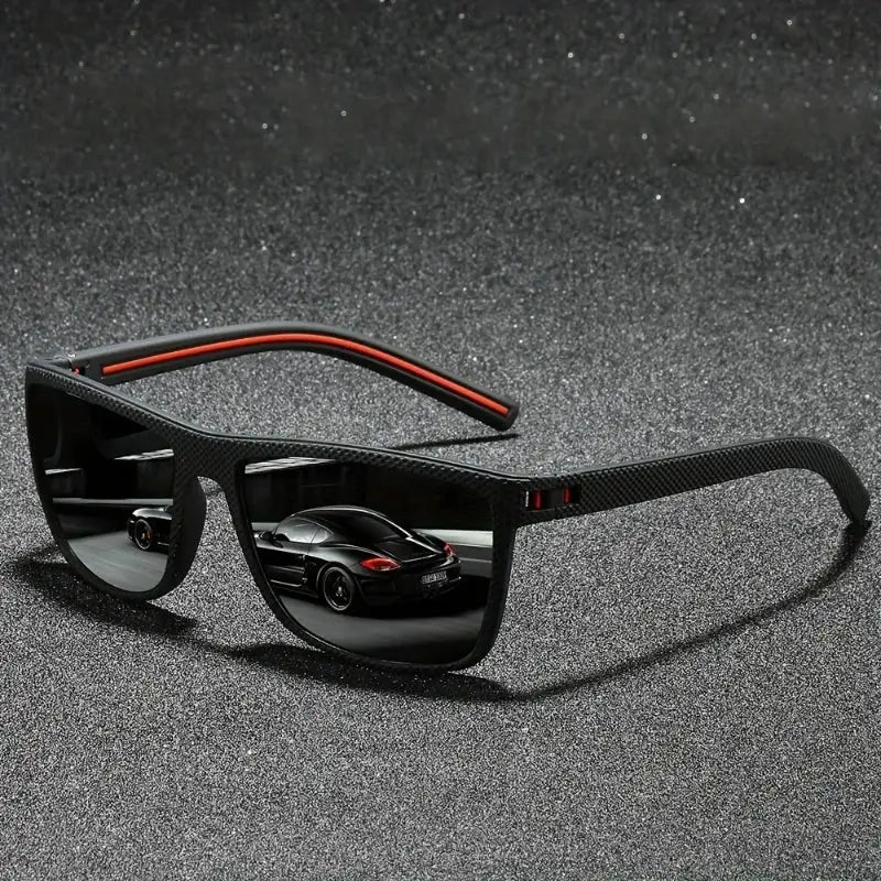 Vintage square polarized sunglasses with black-red frame and UV400 lenses reflecting a luxury car, ideal for driving and outdoor wear.