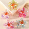 Glossy flower hair clips in pink and gold hues