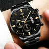 Black luxury fashion watch with gold accents on wrist