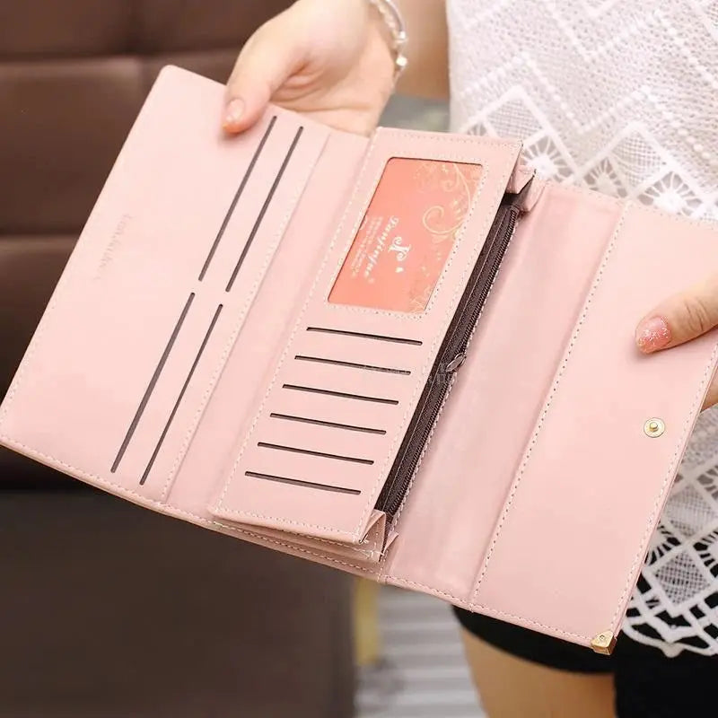 Fully opened Women's Long PU Leather Trifold Wallet in blush pink, showcasing extensive card slots and zippered compartment.