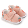 Peach baby shoes with strawberry print