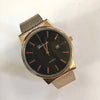 Rose gold mesh band watch with black dial