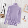 Lavender women's turtleneck sweater on bed