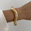 Gold vintage wide bracelet on wrist