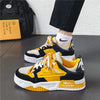 Yellow and black men's sneakers worn with white socks.