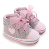 Gray and pink baby sneakers with heart detail