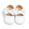 White patent baby shoes with large bow