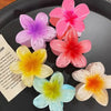 Assorted pastel flower hair clips on a tray