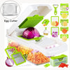 White vegetable cutter with green accents and egg-cutter