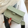 Green faux leather crossbody bag with black strap