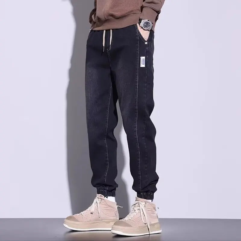 Black casual cargo pants for men with elastic cuffs and drawstring.