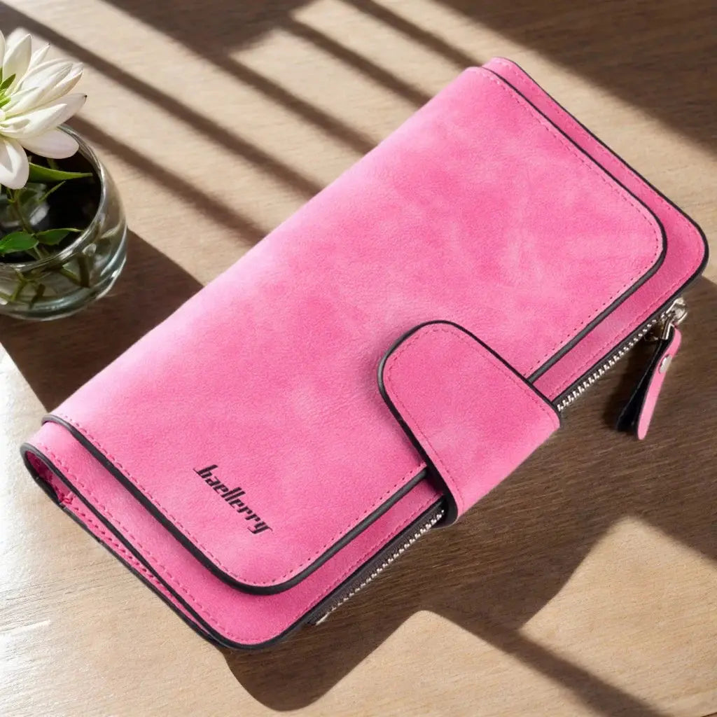 Bright pink women's long trifold wallet with zippered pocket and snap closure, perfect for use as an organizer clutch.