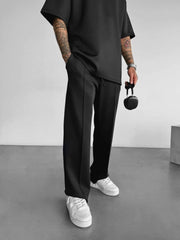 Black men's casual pants with elastic waist and adjustable drawstring.