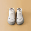 White baby shoes with sleepy face design