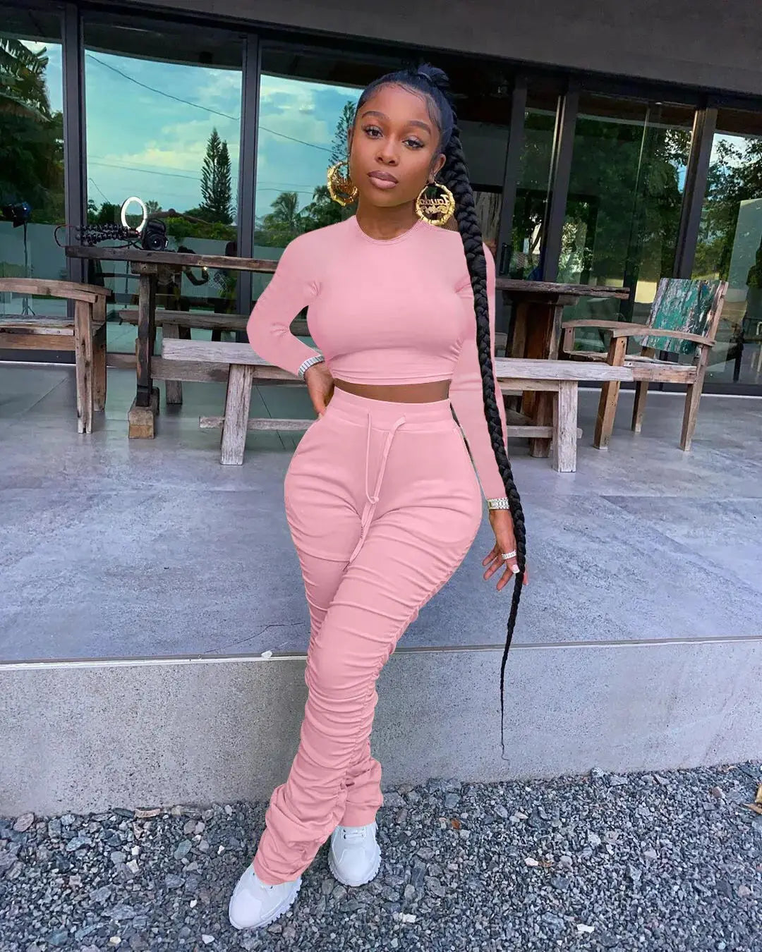Pink Women’s Autumn Two-Piece Sportswear Set styled outdoors with long sleeve crop top and ruched pants, ideal for casual wear.
