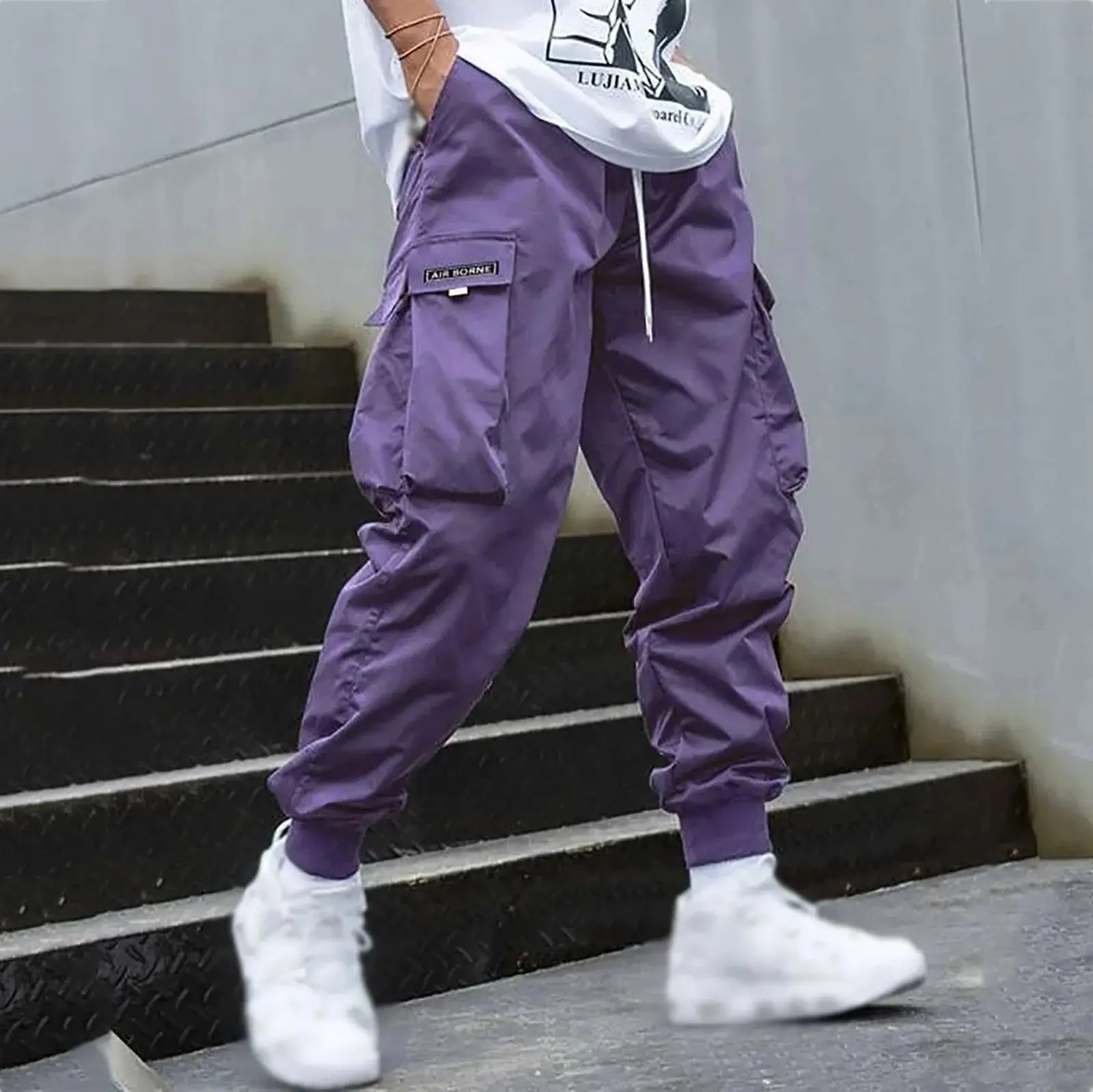 Purple men’s casual cargo jogger pants with drawstring and utility pockets, styled for trendy streetwear or relaxed daily outfits.