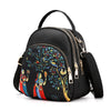 Black backpack with colorful tree artwork