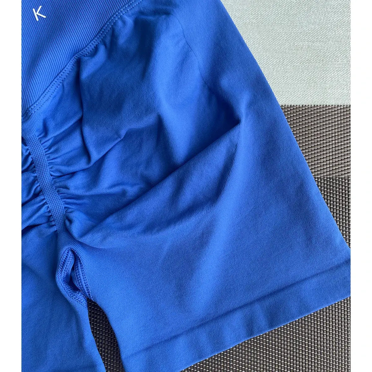 Close-up of Women's 2-Piece Seamless Workout Set featuring soft compression blue shorts with ruched detailing, ideal for gym and activewear use.