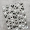 Black and white butterfly nail art stickers on gray sheet