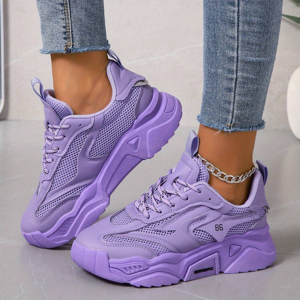 Lavender low-top sneakers for women with cushioned sole and solid color design, great for all-day comfort.