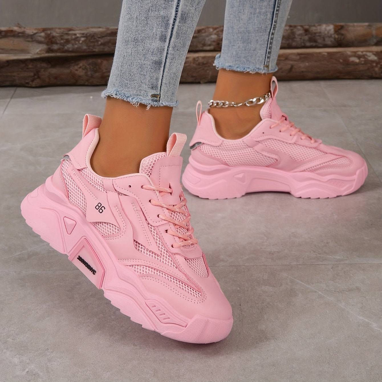 Side view of pink lace-up women’s sneakers with cushioned sole and mesh upper, ideal for daily wear and comfort.