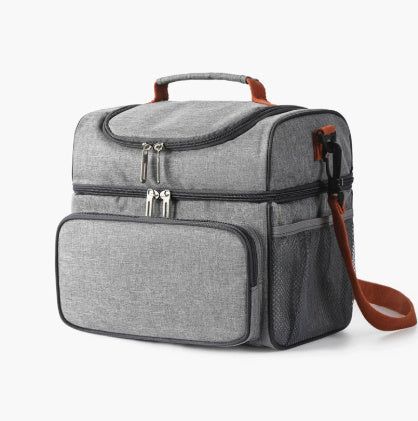 Side angle of grey insulated lunch bag with ice pack, showing front pocket and mesh sides. 10L portable cooler tote for snacks and drinks.