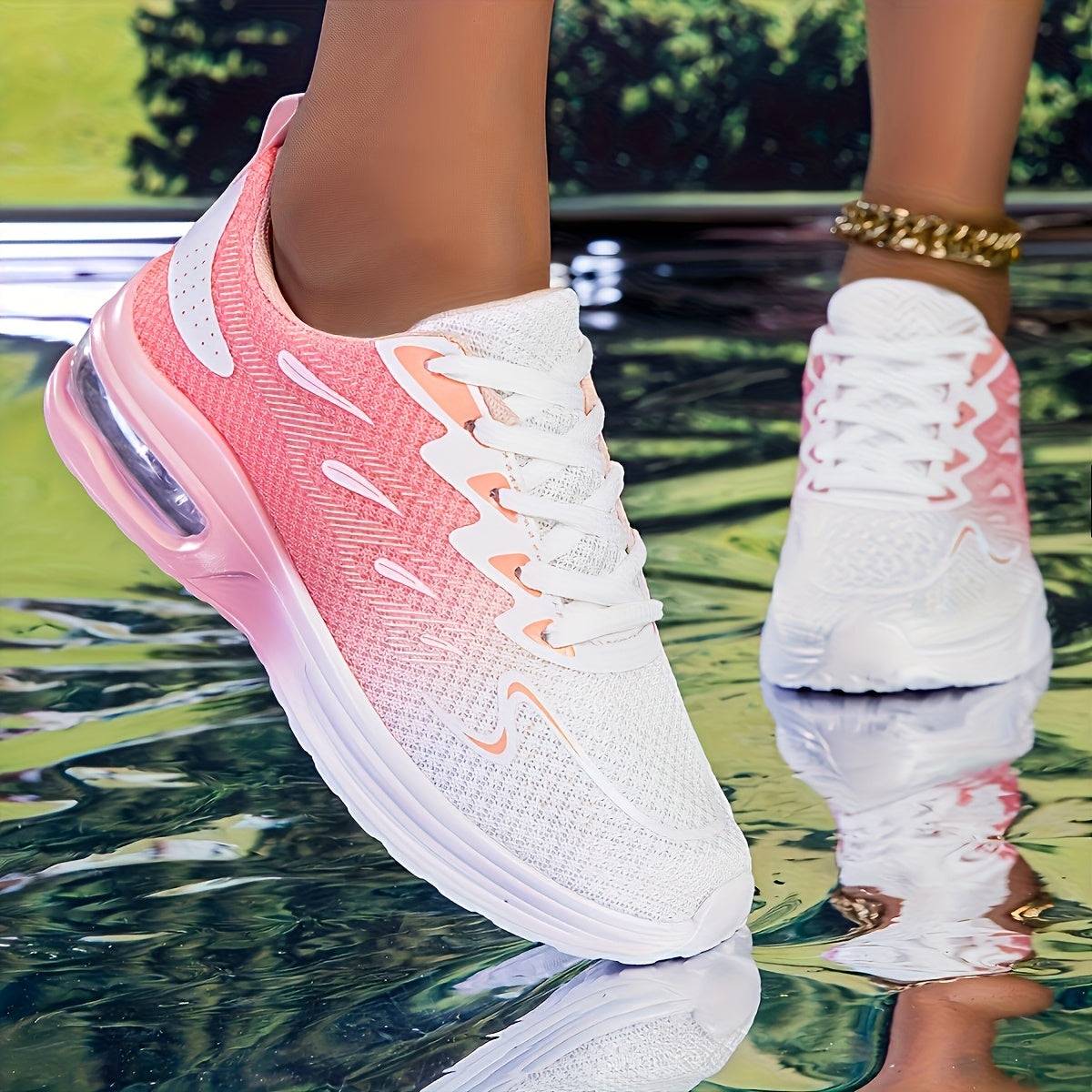 Close-up of pink and white striped women's mesh sneakers with cushioned sole and breathable design for all-day comfort.