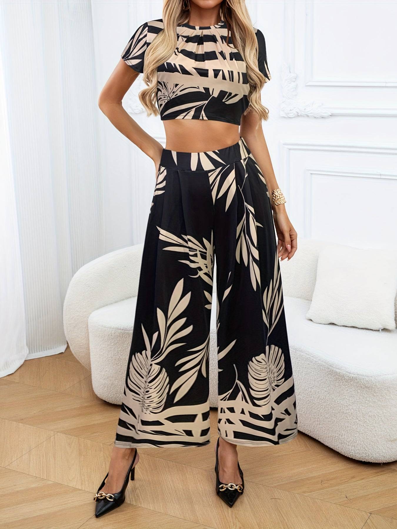 Elegant Women's 2-Piece Leaf Print Summer Set with a round-neck short-sleeve top and wide-leg pants, ideal for resort or vacation wear.